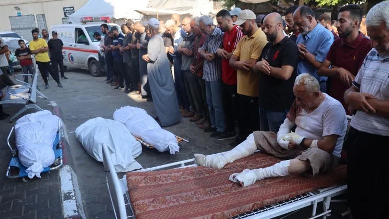 Injured Palestinian man offers funeral prayer for his sons killed in Israeli airstrike