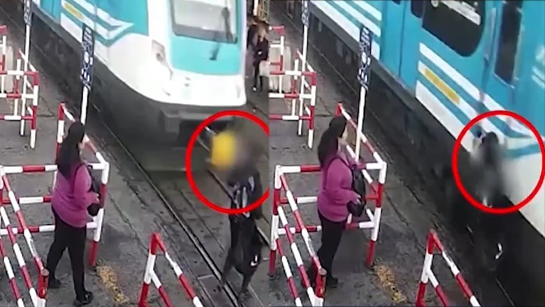 WATCH: Commuter glued to phone narrowly escapes speeding train