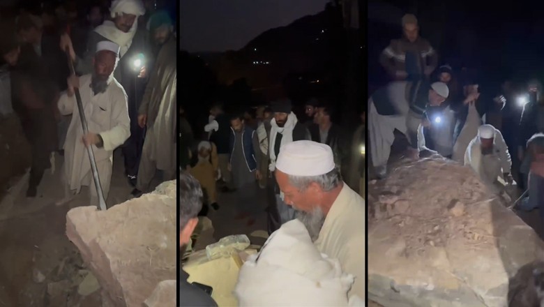 PTI workers smash giant rocks with hammers to clear roadblock