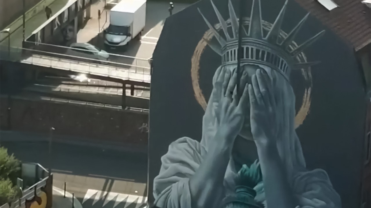Mural in France depicts Lady Liberty covering her face in shame over US policies